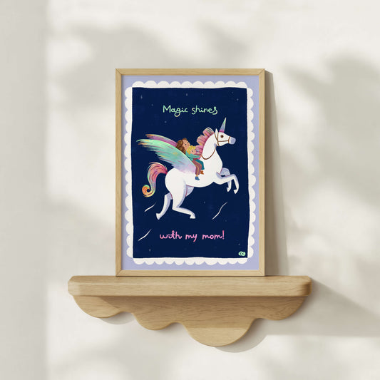 Hand-drawn framed artwork with a unicorn and child illustration on a shelf against a white wall.