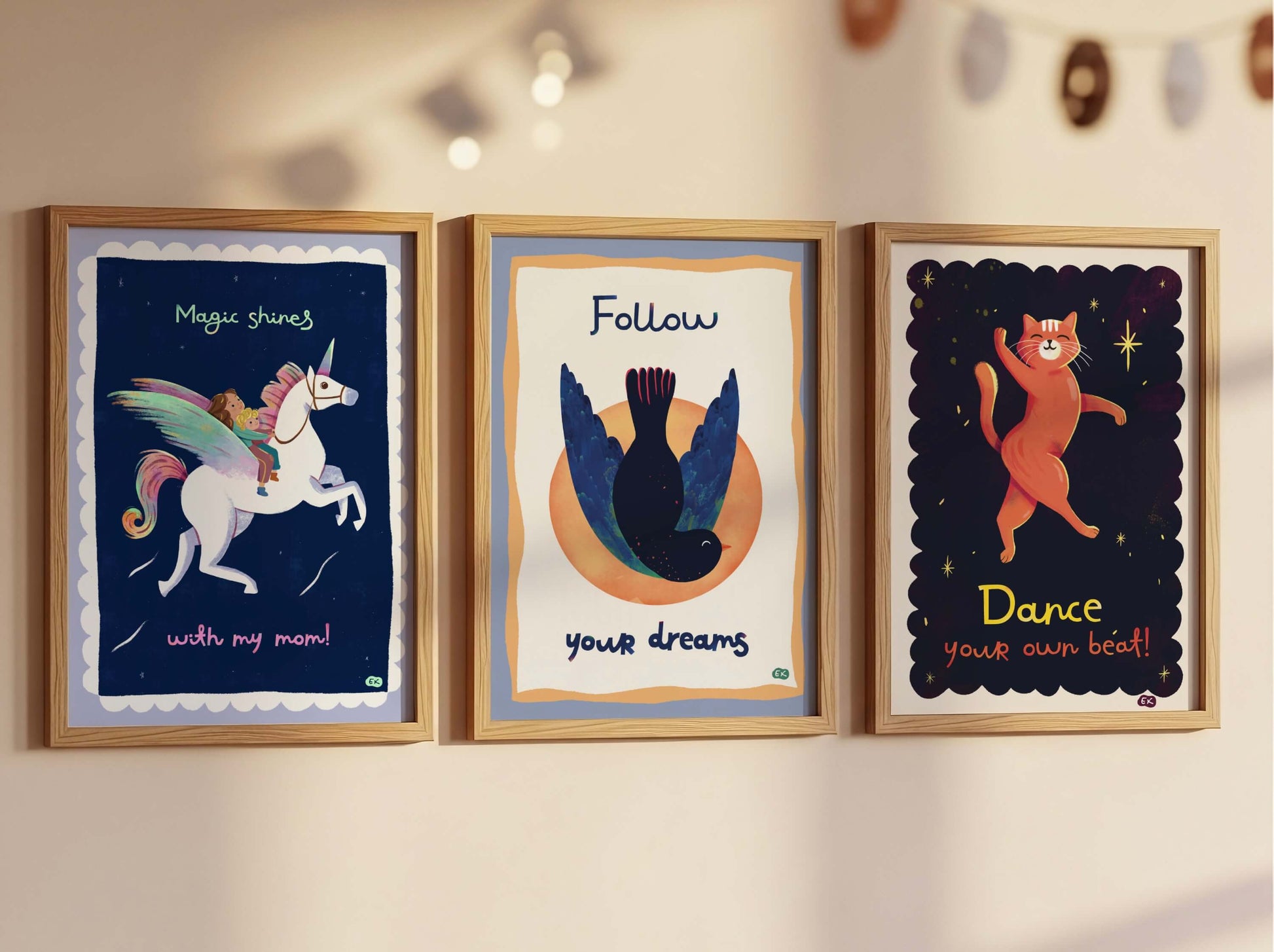 Three framed illustrations on a wall with motivational quotes.