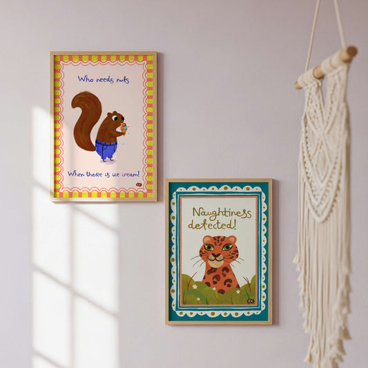 Two framed animal-themed prints on a wall.