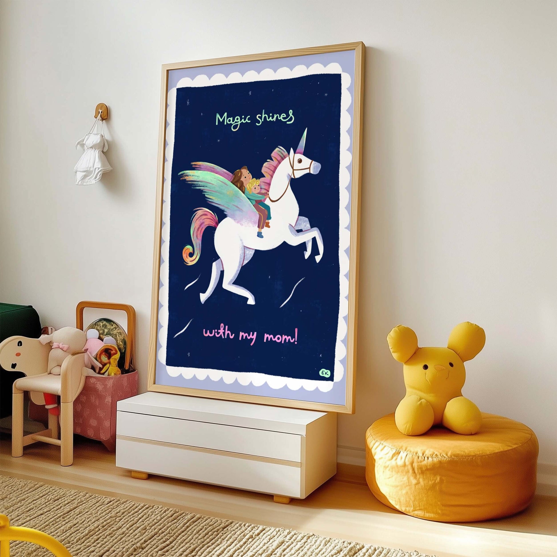 Framed children's poster with a unicorn design in a room with toys and furniture.